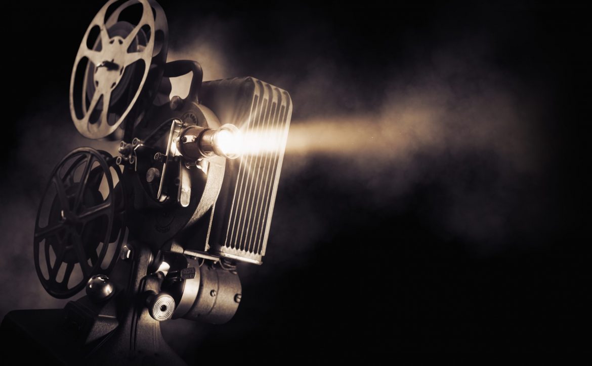 Movie,Projector,On,A,Dark,Background,With,Light,Beam,/